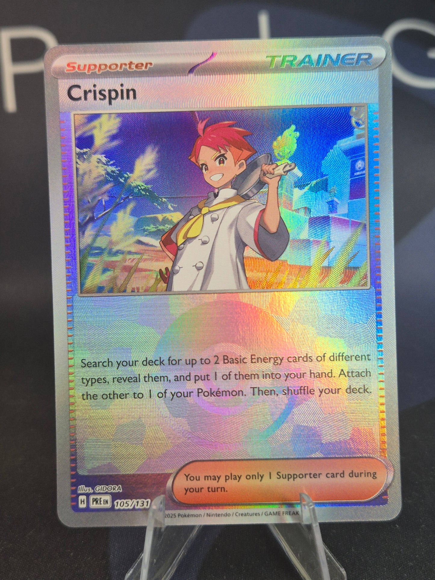 Crispin 105/131 Prismatic Evolutions Pokeball Reverse Holo
